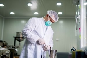 Protective worker at pharmaceutical factory on his work place.