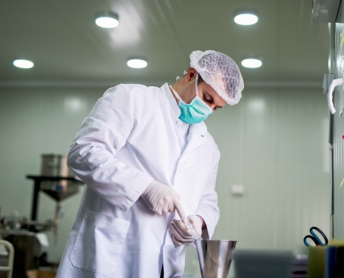 Protective worker at pharmaceutical factory on his work place.